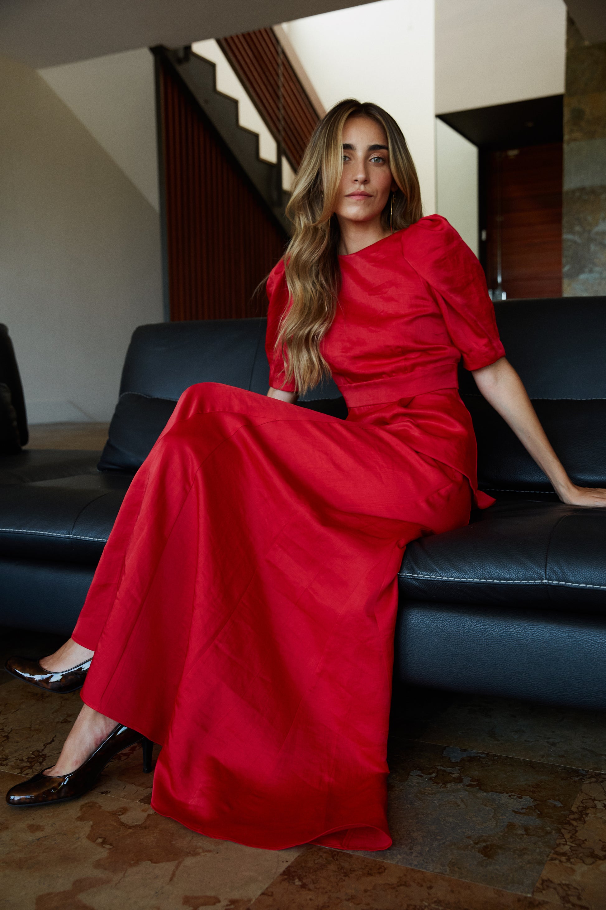 Look de fiesta con top rojo abullonado y falda fluida con godets, outfit sofisticado.